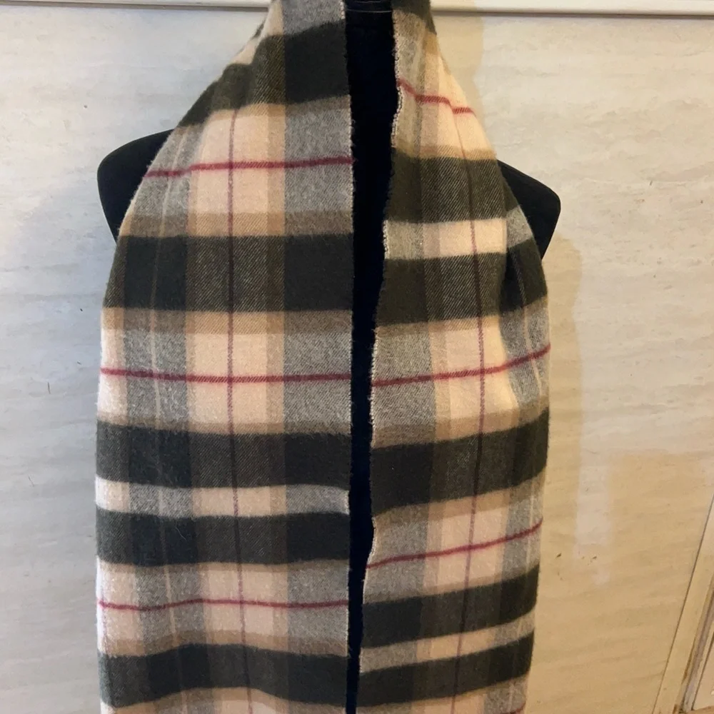 Scarf in a brown,pink, and tan plaid pattern with fringe 100% Cashmere